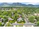 Stunning aerial view of the property nestled among lush greenery with mountain views, showcasing its prime location at 831 Crescent Dr, Boulder, CO 80303