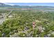 Expansive aerial view highlighting the property's desirable location within a lush, green community near city amenities at 831 Crescent Dr, Boulder, CO 80303