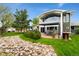 Backyard with an outdoor patio area, seating, a small pond, lush green grass, a trailer, and a house at 831 Crescent Dr, Boulder, CO 80303
