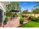 Backyard with an outdoor patio area, seating, pergola, shed, and lush green grass at 831 Crescent Dr, Boulder, CO 80303