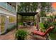 Backyard with an outdoor patio area, seating, pergola, shed, and lush green grass at 831 Crescent Dr, Boulder, CO 80303
