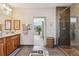 Bathroom with a glass-enclosed shower, double vanity, and an opening to a bedroom with mountain views at 831 Crescent Dr, Boulder, CO 80303