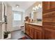 Well-lit bathroom boasts custom wood cabinets, tiled shower, and a decorative rug at 831 Crescent Dr, Boulder, CO 80303