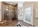 Modern bathroom with a glass-enclosed shower and a soaking tub next to a window at 831 Crescent Dr, Boulder, CO 80303