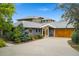 Charming single-Gathering home with a well-manicured lawn, a grey exterior, and an attached two-car garage at 831 Crescent Dr, Boulder, CO 80303