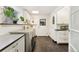 Laundry room features gray tile flooring, updated appliances, and ample cabinet space at 831 Crescent Dr, Boulder, CO 80303