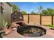 Backyard pond with a small waterfall feature, colorful statues, and lots of plant life at 831 Crescent Dr, Boulder, CO 80303