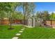 Backyard shed with a white and green color scheme and a small seating area at 831 Crescent Dr, Boulder, CO 80303