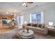 Virtually staged dining area and living room with a fireplace at 19556 E 58Th Pl, Aurora, CO 80019