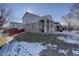 Side view of a two-story home with a red fence and snowy lawn at 19556 E 58Th Pl, Aurora, CO 80019