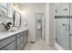 Modern bathroom featuring a double sink vanity, glass shower, and neutral color palette at 2052 Alcott Way, Broomfield, CO 80023
