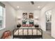 Cozy bedroom with neutral tones, decorative pillows, bedside lamps, and ensuite bathroom access at 2052 Alcott Way, Broomfield, CO 80023