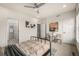 Serene bedroom with neutral tones, modern artwork, ceiling fan, and an ensuite bathroom at 2052 Alcott Way, Broomfield, CO 80023