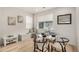 Bright dining area featuring modern furnishings, a window bench, hardwood floors, and natural light at 2052 Alcott Way, Broomfield, CO 80023