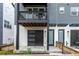 Stylish modern entrance featuring a sleek garage door and inviting front door at 2052 Alcott Way, Broomfield, CO 80023