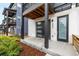 Inviting modern entrance featuring a sleek garage door, and stylish front door at 2052 Alcott Way, Broomfield, CO 80023
