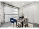 Bright home office with garage door access, modern desk, and comfortable seating at 2052 Alcott Way, Broomfield, CO 80023