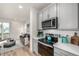 Modern kitchen featuring gray cabinets, stainless appliances, a white subway tile backsplash and hardwood floors at 2052 Alcott Way, Broomfield, CO 80023