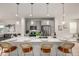 Modern kitchen featuring a large island with seating, stainless steel appliances, and pendant lighting at 2052 Alcott Way, Broomfield, CO 80023