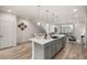 Modern kitchen featuring a large island with seating and stainless steel appliances at 2052 Alcott Way, Broomfield, CO 80023