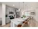 Open-concept kitchen featuring a large island with seating, stainless steel appliances, and stylish lighting at 2052 Alcott Way, Broomfield, CO 80023