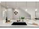 Bright kitchen featuring an island with a sink and stylish pendant lighting at 2052 Alcott Way, Broomfield, CO 80023