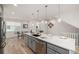 Open kitchen featuring a large island with seating, stainless steel appliances, and modern finishes at 2052 Alcott Way, Broomfield, CO 80023
