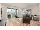 Bright living room featuring a balcony, modern furnishings, hardwood floors, and plenty of natural light at 2052 Alcott Way, Broomfield, CO 80023