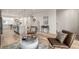 Open floor plan with hardwood floors connecting the kitchen, dining area, living room, and staircase at 2052 Alcott Way, Broomfield, CO 80023