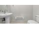 Simple powder room featuring a pedestal sink, round mirror, heater, and a toilet at 2052 Alcott Way, Broomfield, CO 80023