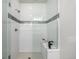Contemporary shower with glass enclosure, sleek white tile, and elegant mosaic accent at 2052 Alcott Way, Broomfield, CO 80023