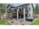 Wonderful backyard space featuring a deck with seating and a hot tub on the lower patio at 1151 Kenosha Dr, Larkspur, CO 80118