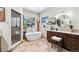 Luxurious bathroom with soaking tub, glass shower, and dual vanity at 1151 Kenosha Dr, Larkspur, CO 80118