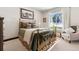 Cozy bedroom with a brass bed frame and window seat at 1151 Kenosha Dr, Larkspur, CO 80118