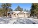 Spacious ranch home with a three-car garage, covered entry, and snowy landscape at 1151 Kenosha Dr, Larkspur, CO 80118