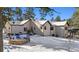Back exterior of house with patio and firepit area at 1151 Kenosha Dr, Larkspur, CO 80118