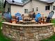 Stone fire pit area with Adirondack chairs, creating a cozy and inviting outdoor space at 1151 Kenosha Dr, Larkspur, CO 80118