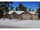 Attractive single-Gathering home with a snow-covered roof and a two-car garage at 1151 Kenosha Dr, Larkspur, CO 80118