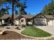 Charming single-story home featuring a well-manicured lawn and rock landscaping at 1151 Kenosha Dr, Larkspur, CO 80118