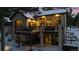 Two-story house with a deck, hot tub, and snowy landscape at dusk at 1151 Kenosha Dr, Larkspur, CO 80118