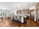 Bright kitchen featuring a central island with bar seating and modern lighting fixtures at 1151 Kenosha Dr, Larkspur, CO 80118