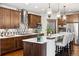 Open concept kitchen with island seating and stainless steel appliances at 1151 Kenosha Dr, Larkspur, CO 80118