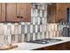 Modern kitchen backsplash with a gas range and stainless steel appliances at 1151 Kenosha Dr, Larkspur, CO 80118