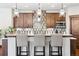 Modern kitchen features wood cabinets, quartz countertops, and stylish pendant lighting at 1151 Kenosha Dr, Larkspur, CO 80118