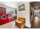 Laundry room with red appliances and wooden bench at 1151 Kenosha Dr, Larkspur, CO 80118