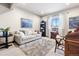 This room features a comfortable couch, a window with natural light, and tasteful decorations at 1151 Kenosha Dr, Larkspur, CO 80118