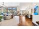 Open floor plan with hardwood floors, a cozy fireplace, and large windows at 1151 Kenosha Dr, Larkspur, CO 80118