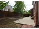 Large, fenced backyard features mature trees, concrete patio, and professional landscaping at 20630 E Hamilton Ave, Aurora, CO 80013