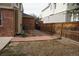 View of the side yard with brick pavers, an air conditioning unit, and wooden fencing at 20630 E Hamilton Ave, Aurora, CO 80013