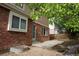 Red brick backyard features a new concrete patio, a well, and mature trees for backyard shade at 20630 E Hamilton Ave, Aurora, CO 80013